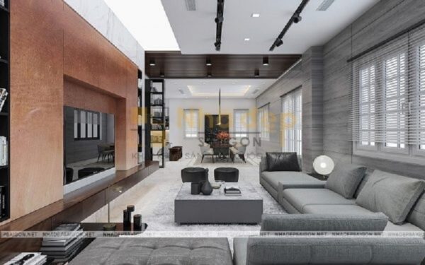 Phòng khách trông thông thoáng và tiện nghi hơn rất nhiều khi thiết kế bộ sofa hình chữ L, chiếc bàn trà hình vuông cùng tông màu với thảm trải nhà và sofa, kệ tivi được áp sát tường đã tạo nên một bố cục phòng khách khoa học.